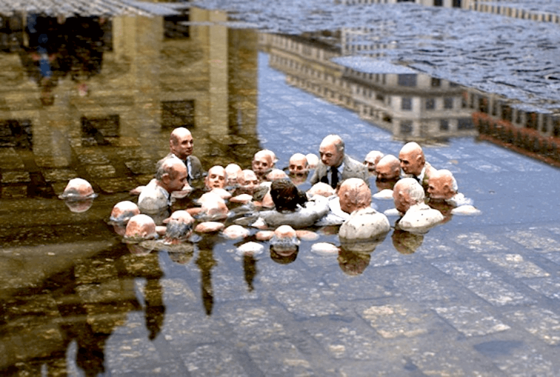 Isaac Cordal’s tiny cement sculpture in Berlin: “Follow the Leaders” – politicians discussing climate change.