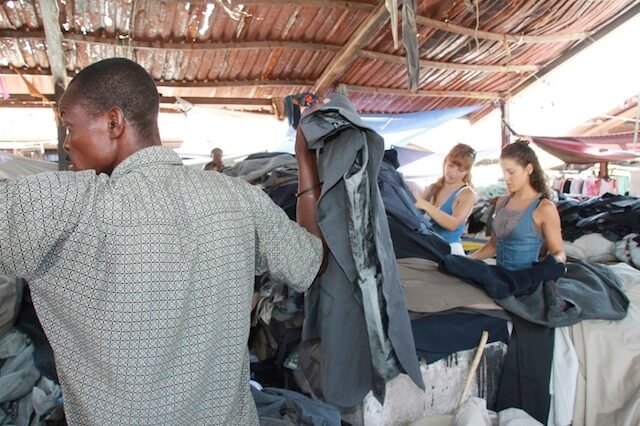 Local Buttons sourcing materials at a second-hand clothing market in Haiti