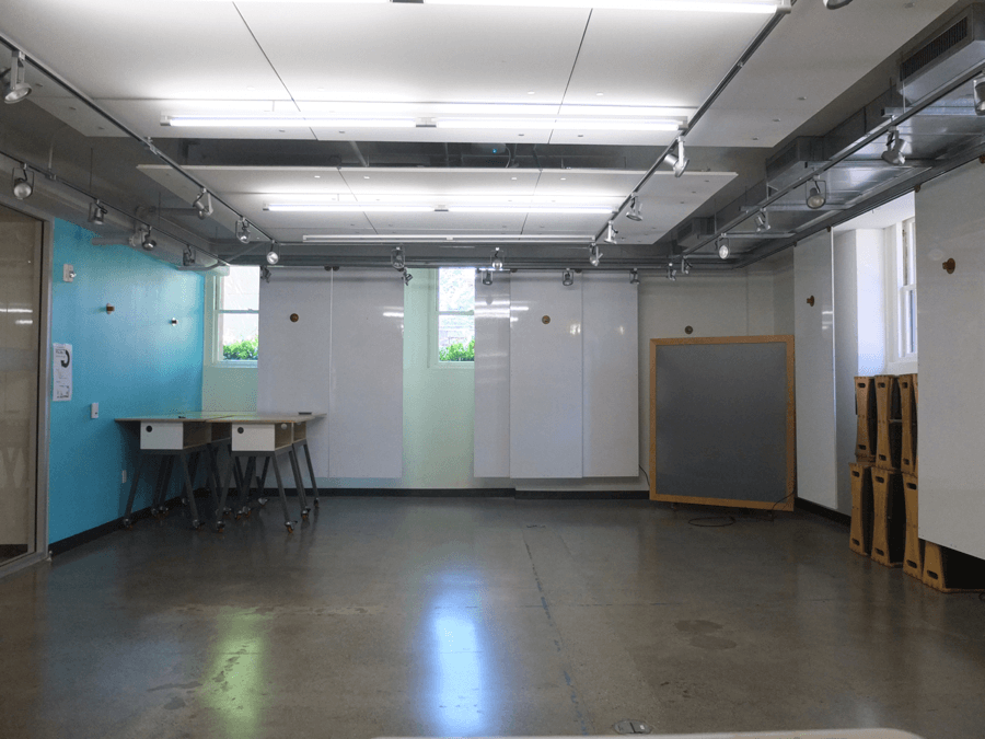 The furniture is neatly arranged for the next group who may need to use the space. (Notice all of the hanging whiteboards!)