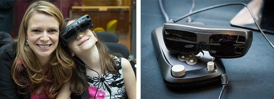 A young girl wearing eSight glasses