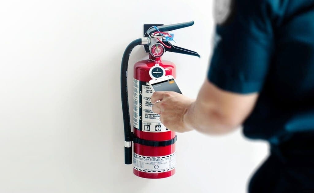 Rapid Evac inspecting a fire extinguisher