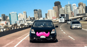 a Lyft vehicle with the signature pink mustache